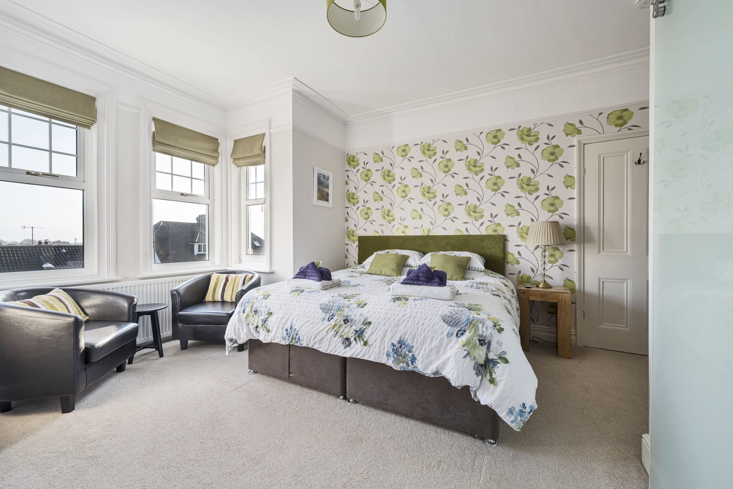 A very spacious, comfortable and light double en-suite room with far reaching sea views. The room is furnished with a super king size bed, a range of solid white oak furniture with plenty of space for belongs, a couple of leather tub seats in the bay window for guests to relax in and a 55 inch smart TV. Tea and coffee making facilities are also provided in the room. The stylish en-suite bathroom is equipped with a large walk-in power shower, hand basin, mirror and lavatory. Towels, robes and slippers are provided for guests comfort.